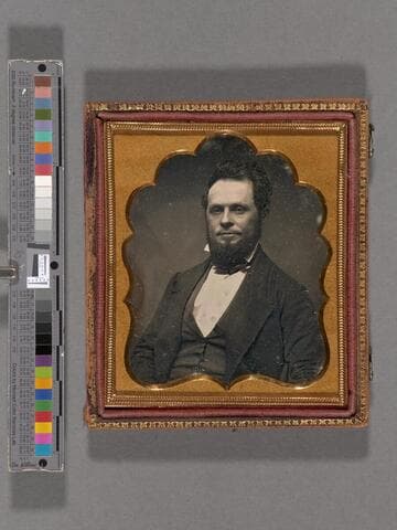 Portrait of unidentified man with full beard, wearing suit