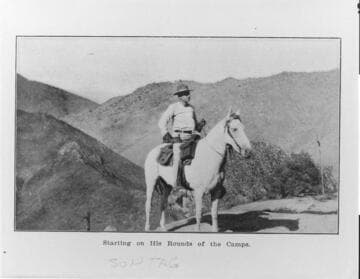 A man on horseback in the mountains "starting on his rounds of the camps