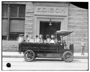 Electric wagon with display of running electric fans (running) set up in front of the Edison Building