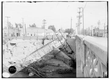 Kern River & Borel Transmission Line - Three boys and two women with baby carriage looking at a fallen tower, resulting from storm of February 20, 1914.  This is the north view, and in the background is the Price-Corcoran