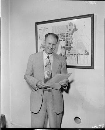 Man with paperwork standing next to map of South Pasadena