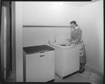 Woman loading washing machine