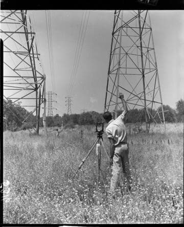 Surveyors working in a transmission line corridor