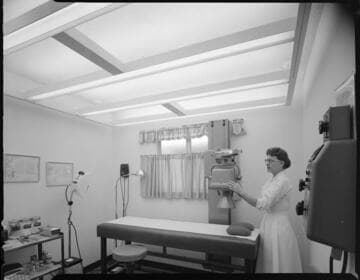 Lady working with X-ray equipment in a doctors office