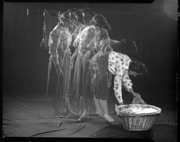 Multi exposure image of woman moving washed clothes from basket to clothesline