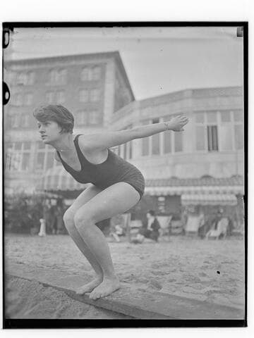 Swimmer in dive pose in front of Club Casa del Mar, Santa Monica, California