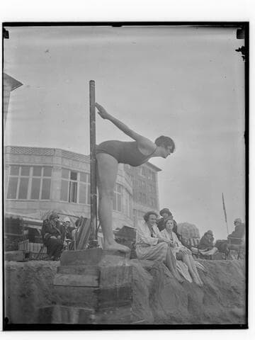 Swimmer in dive pose in front of Club Casa del Mar, Santa Monica, California
