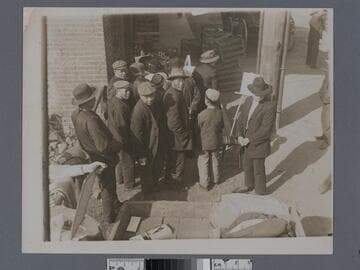 Group of Chinese men in front of easels and market, Old Chinatown, Los Angeles