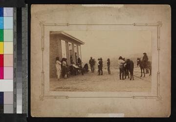 A group of Apache Indians and a white man at unidentified location