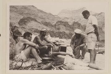Camp at lower end of Stanton's Switching Yard. Between Bass Cable and Shinumo Creek. Garth Marston at left; then Larry Sanderson, John Schulz, and Chuck Richey. Buzz Belknap is lying in the foreground