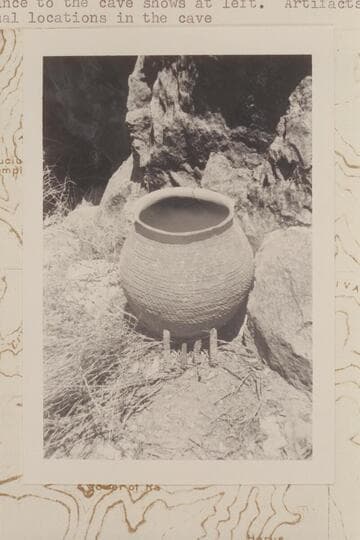 Olla and prehistoric cobs at mouth of Olla Vieja Cave on the slope of Osiris Temple where Donald Davis found them 1966, May 31. The entrance to the cave shows at left. Artifacts were returned to original locations in the cave