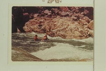 Buzz Belknap tests a Sportyak by carrying a passenger through Gneiss Canyon Rapid