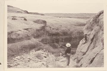 Looking down the old Stanton Dredge road.  Nancy Gilmer in foreground is standing on bedrock.  Harry Aleson stands on another section of the road in the background.  All the roadbed has washed away down through the middle section