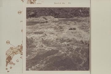 Across from left bank below head of Rapid 22 in The Big Drop. The rock with the rounded top appears in 2711 CTCN 3 and in Bennett #8-90 of 1964, June. In this Sleight photo the river stage is higher than in the 1927 and 1964 photos