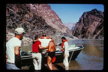 Lifting Komie[sp?] into circle boat at 231 Mile Rapids