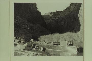 Fishing at camp at the mouth of Tapeats Creek.  Left to right:  Desloge, Forcier and Marston.  The motorboat in the lagoon