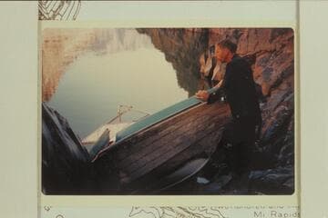 Jorgen Visbak examines the wreck of the inboard-outboard hull from which the power unit was salvaged after it had been wrecked in 232 Mile Rapid