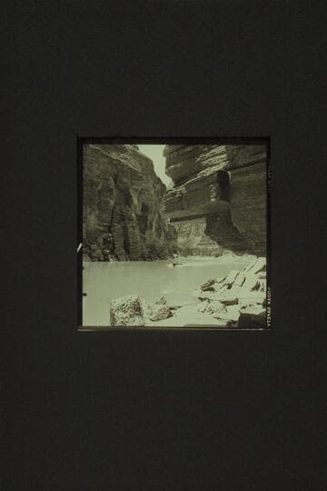 One of the boats coming back up the river after examination of Upset Rapid, Mile 150. Lunch had been under the overhang