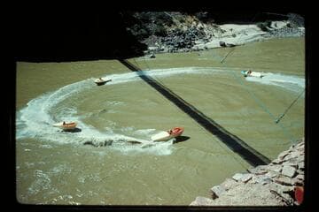 Four boats circle under bridge at Bright Angel Creek
