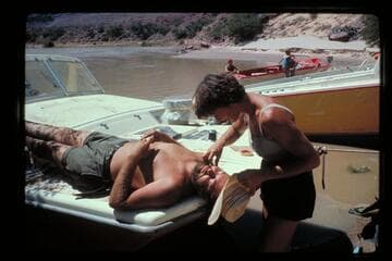 Camp above Unkar Rapids; Joyce trims Jim's beard
