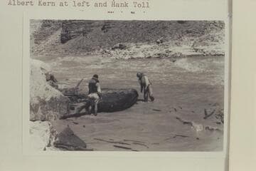 Albert Kern and Hank Toll salvage the "Dark Angel" at right bank of 24.5 Mile Rapid