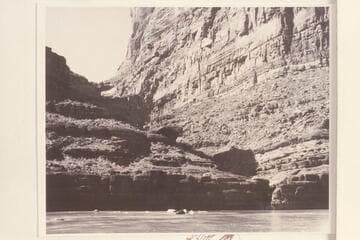 Cove Canyon with boulder in stream course.  The head of Powell Puddle has almost submerged the bar at the mouth of the canyon