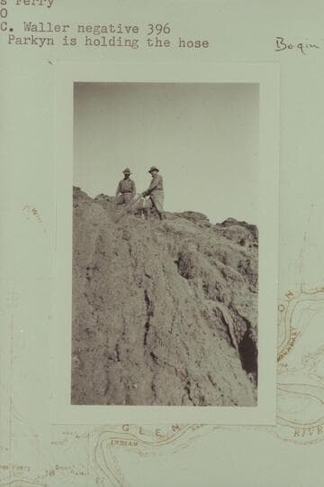 Dr. Parkyn and Daniels washing down the Chinle silts. Lees Ferry. Dr. Parkyn is holding the hose