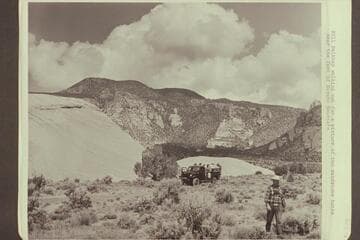 Bill Belknap walking out for a picture of the sandstone butte near the foot of Navajo Mountain