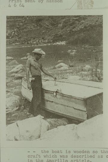 Clarke Lium with wrecked Cataract boat at Mille Crag, Sheep Canyon