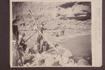 Stranded boat in Dark Canyon Rapid. On the boat: Emery (left) and Ellsworth