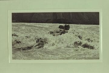 Dock Marston and Buzzy Belknap swimming through Paria Riffle