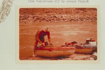 Bill Belknap finishing the packing of the Sportyak. Camp at Mile 204.9 opposite the mouth of Range Canyon