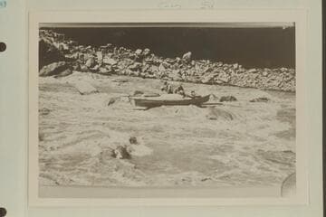 The Kolb brothers at salvage operations in the boat rock-locked in Dark Canyon Rapids. USGS Cataract Canyon survey under W. R. Chenoweth. Copy of small print loaned by Chenoweth