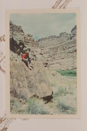 Jody Baker on the boulder which bears the Brown-Stanton inscription.  Left bank of the Colorado below the mouth of the Green