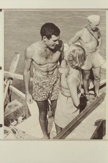 Garth Marston is greeted by Shirley at the head of Lake Mead; end of 1948 traverse of the Grand Canyon. Moulty Fulmer is at right
