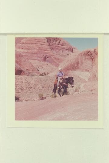 Dock Marston rides up trail out of canyon at 71.5