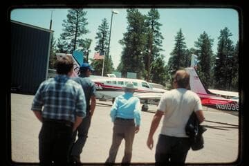 Emery Kolb leaving the plane after his flight up to Marble Canyon down in the river gorge