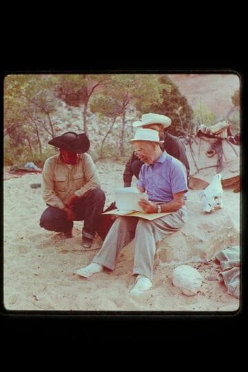 Dock shows maps and pictures to Dan and Bale[?]; Surprise Valley