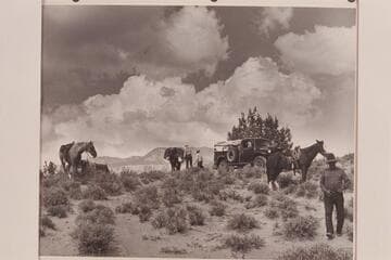 Changing from truck to pack string. Rainbow Plateau at edge of Navajo Canyon. Nancy & Tom Daly work at the packs. Whitehat at right
