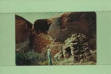 Aleson standing by old fireplace on bar at Camp Stone in Glen Canyon