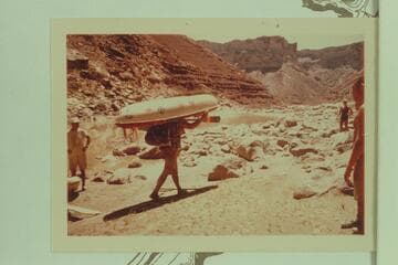 Bill Belknap strides off with a portage at Soap Creek Rapid using the tecnhique which had been planned