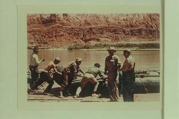 Launching the neoprene craft of the Hatch-Dines trip in 1954. Walt Emery; Tyson Dines; Allan Smith; Jim Nelson; Smuss Allen; and Bus Hatch. Lees Ferry