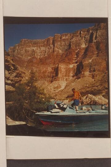 Rod Sanderson stepping out of the boats which are moored in the lagoon at the Little Colorado