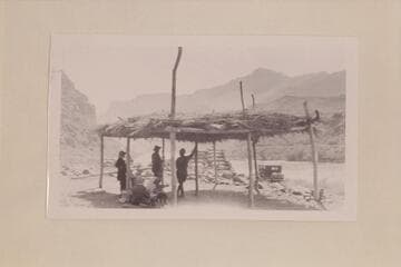 Zahn party under shelter at Lees Ferry.  The Zahn car in the background