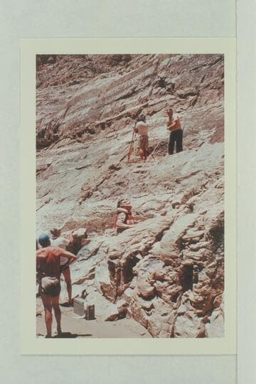 Rigging the camera at Paradise Canyon. Dick Kelley is at the camera and Doc Reed is hauling gear. Jim Algar climbs to the camera position. Gordon Avil handles the line from the beach as Doc Hill looks on