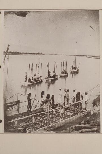 The start from Camp Mojave, Arizona. Boat expedition under Lieut. Wheeler, the first and only one to ascend the Colorado River through the Grand Canyon to the mouth of Diamond Creek. Note ferry in foreground which appears to have a rig for a sail