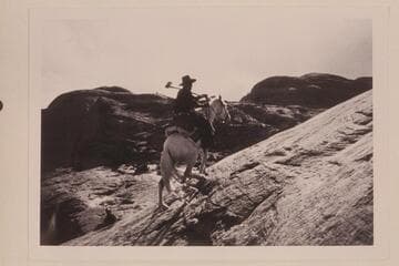 Tobe Owl rides the trail west of Nasja Creek and about opposite its dropoff near the San Juan River