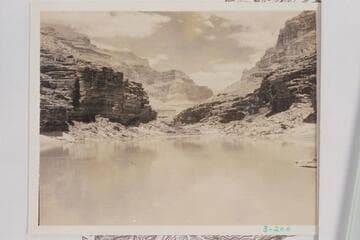 Downriver from the lunch stop of 1934, July 29, below Fossil Rapid about Mile 125.6.  The granite of the Middle Granite Gorge could be seen downriver.  In 1937, Sharp placed the appearance of the Archean at 200 yds. above 127 Mile Rapid