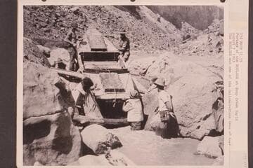 Portage of the "Boulder" at Soap Creek Rapid.  The "Boulder" was one of the Galloway-Stone type of boat used by the USGS in their traverse of the Canyon to make the present-day profile maps