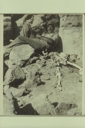 Bill Davis posing with the skeleton near Vaseys Paradise.  Mile 31 1/2 Marble Canyon.  The Sheriff had investigated the skeleton a dn Dr. Hume rearranged the bones in order when he visited here in 1952